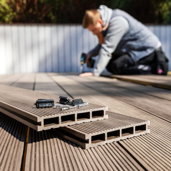 A modern composite deck being installed – a durable and stylish option for maximizing outdoor space with custom designs